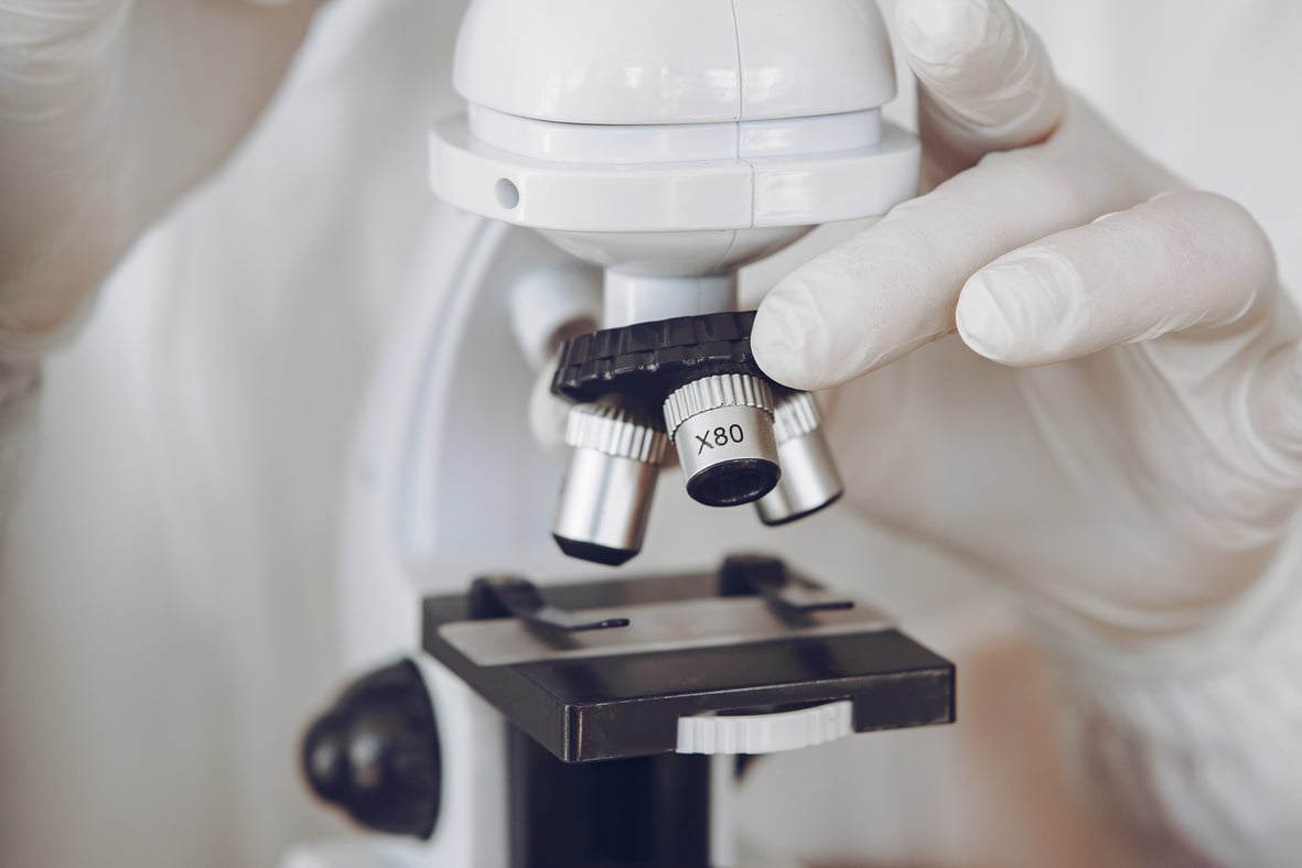 Person Holding Microscope